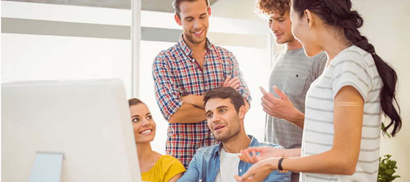 People collaborating at computers in an office