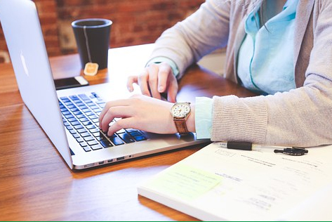 Woman typing on laptop